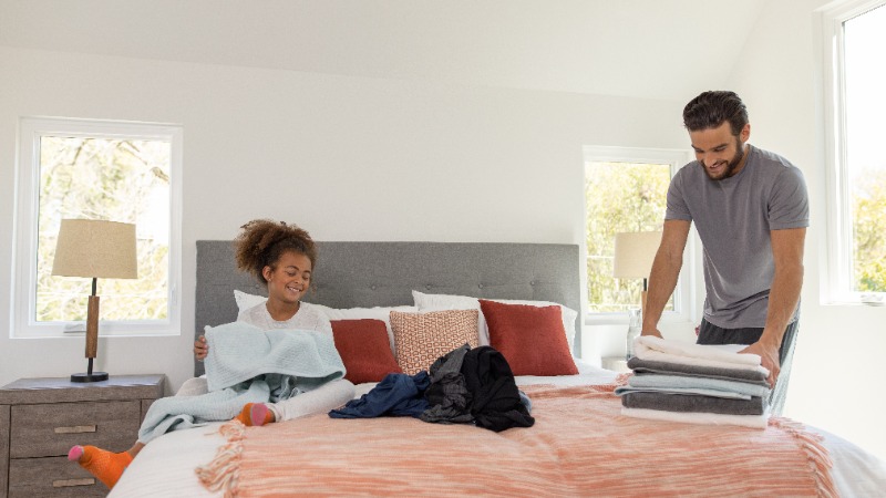 Family folding fresh, soft laundry together